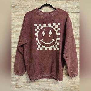 Corduroy crewneck sweatshirt with a white checkerboard and lightning bolt smiley